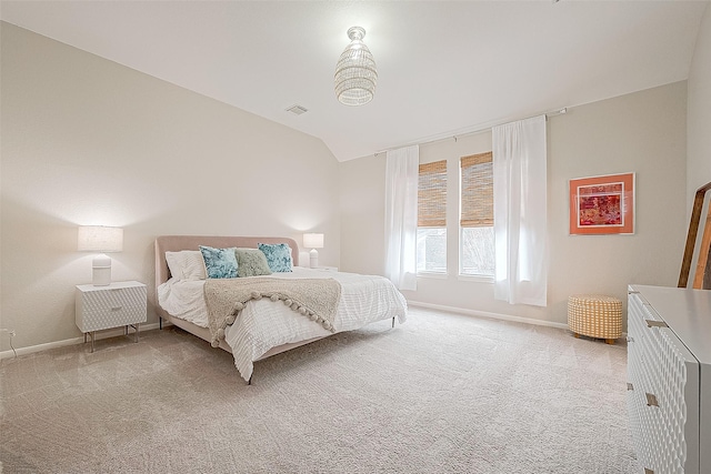 carpeted bedroom featuring vaulted ceiling