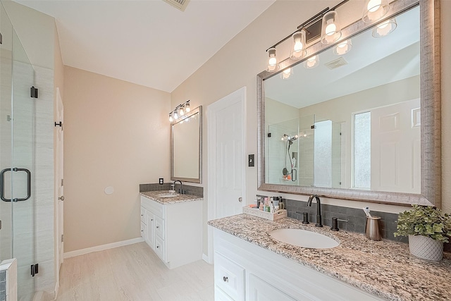 bathroom featuring vanity, lofted ceiling, and walk in shower