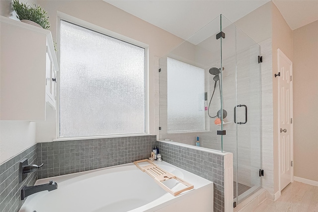 bathroom with shower with separate bathtub