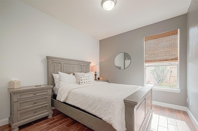 bedroom featuring vaulted ceiling and dark wood-type flooring