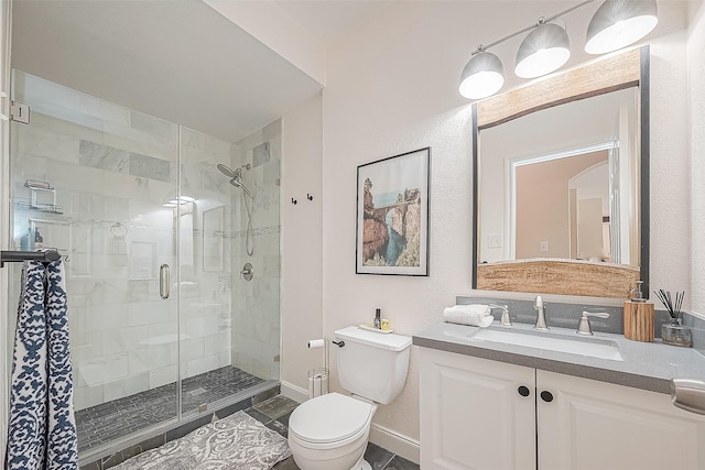 bathroom featuring vanity, toilet, and an enclosed shower