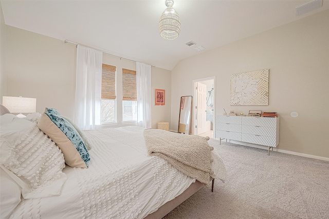 carpeted bedroom with lofted ceiling