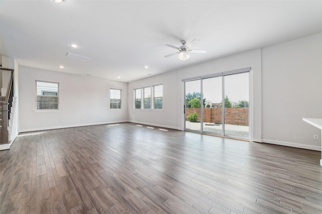 unfurnished living room featuring dark hardwood / wood-style floors and ceiling fan