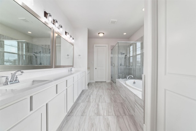 bathroom featuring vanity and shower with separate bathtub