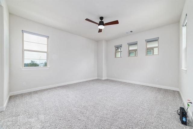 unfurnished room with ceiling fan and carpet flooring