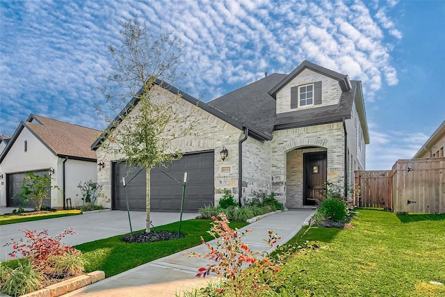 french provincial home featuring a garage and a front yard