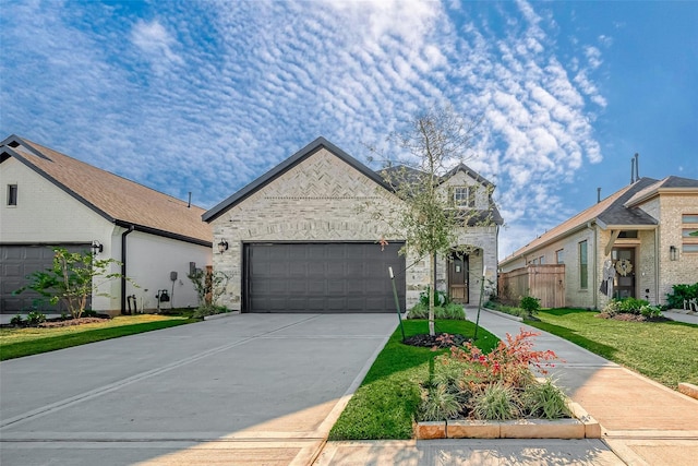 view of front of property with a garage and a front lawn