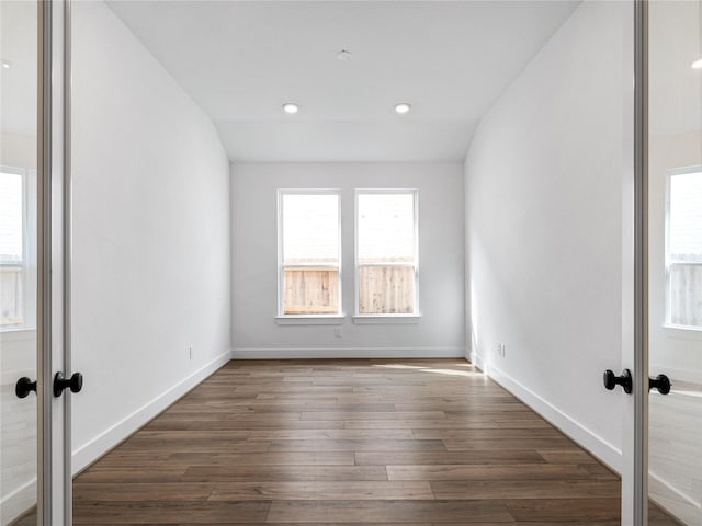 empty room with dark wood-type flooring and french doors