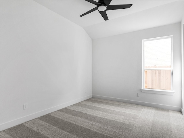 spare room with lofted ceiling, carpet floors, and ceiling fan