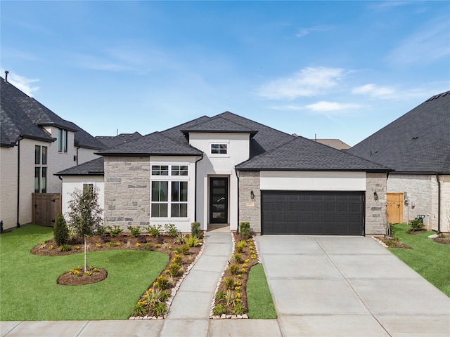 view of front of house with a garage and a front yard