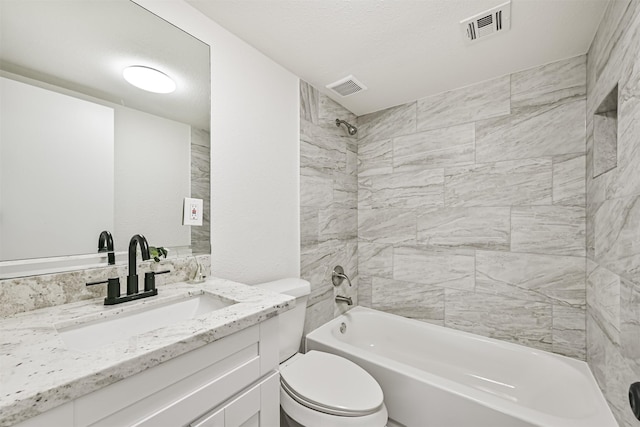 full bathroom with vanity, tiled shower / bath, and toilet