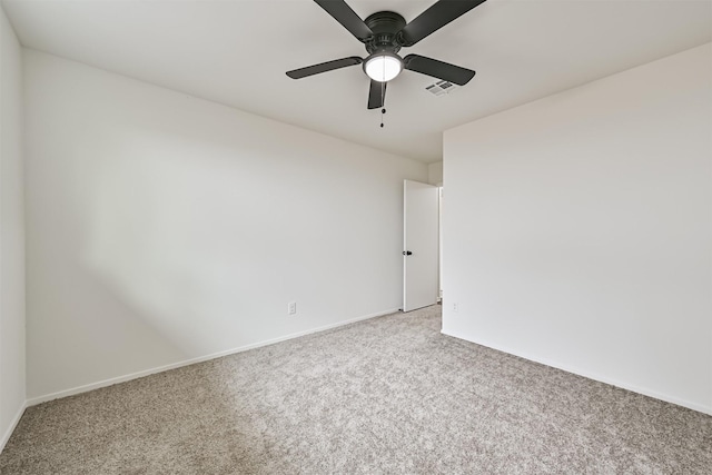 spare room featuring ceiling fan and light colored carpet