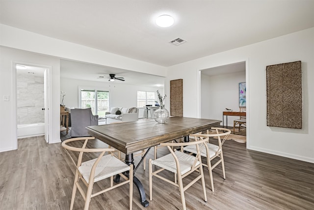 dining room with ceiling fan and hardwood / wood-style floors