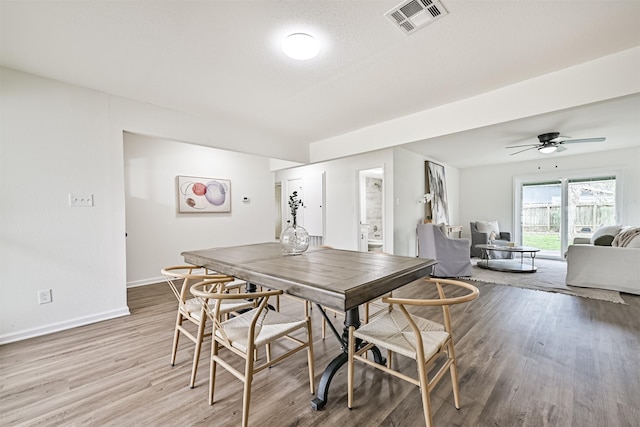 dining room featuring wood-type flooring and ceiling fan