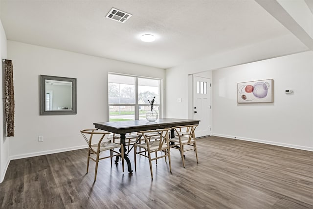 dining space featuring dark wood-type flooring