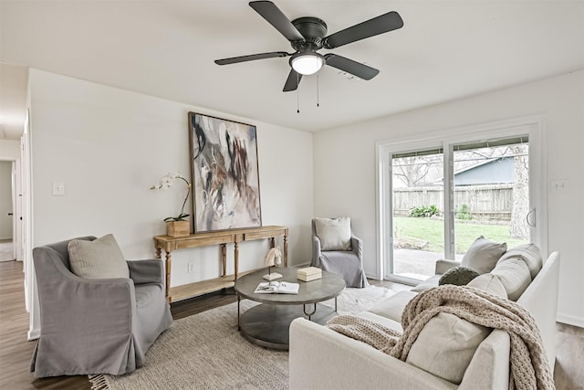 living room featuring hardwood / wood-style floors and ceiling fan