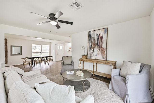 living room featuring ceiling fan and wood-type flooring