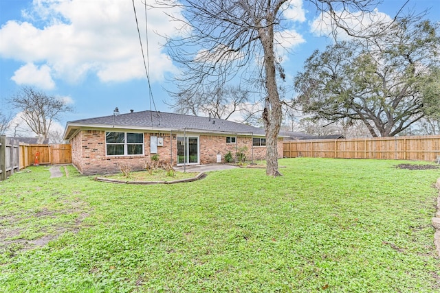 rear view of house with a yard and a patio area