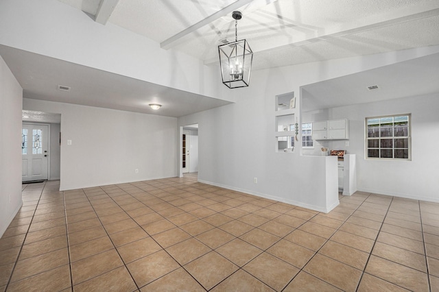 unfurnished dining area featuring light tile patterned flooring, a notable chandelier, a healthy amount of sunlight, and vaulted ceiling with beams