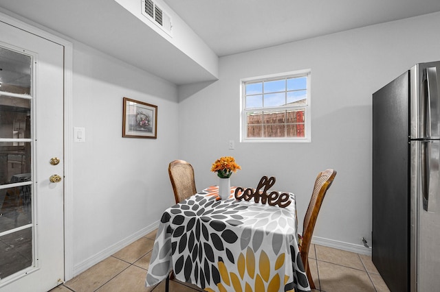 dining space with light tile patterned floors