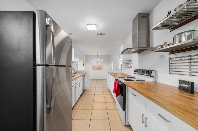 kitchen featuring white cabinetry, decorative light fixtures, stainless steel appliances, and island exhaust hood