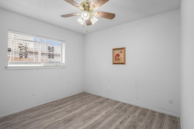 unfurnished room with ceiling fan, a textured ceiling, and light hardwood / wood-style floors