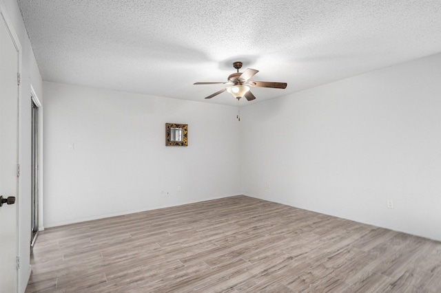 spare room with ceiling fan, light hardwood / wood-style floors, and a textured ceiling