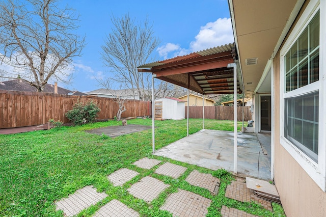 view of yard featuring a storage shed and a patio