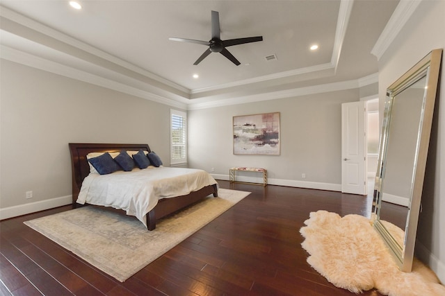 bedroom with dark wood-type flooring, ornamental molding, a raised ceiling, and ceiling fan