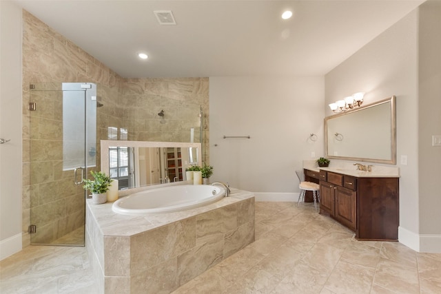 bathroom with vanity and separate shower and tub