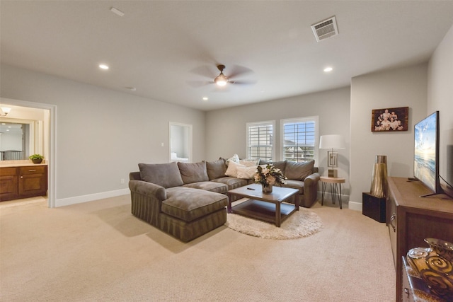 carpeted living room with ceiling fan