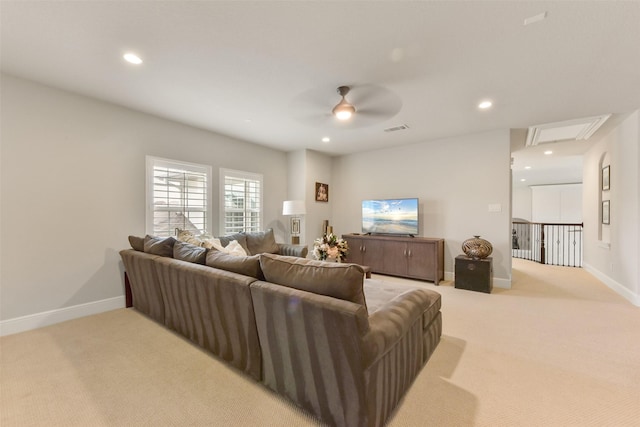 carpeted living room with ceiling fan