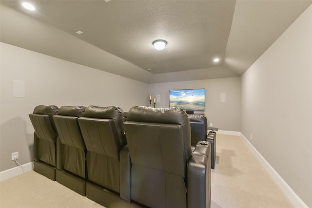 home theater featuring lofted ceiling, a textured ceiling, and carpet flooring