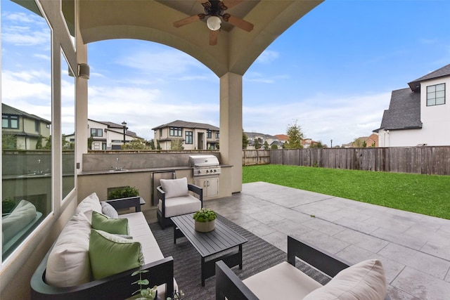 view of patio / terrace with exterior kitchen, a grill, an outdoor hangout area, and ceiling fan