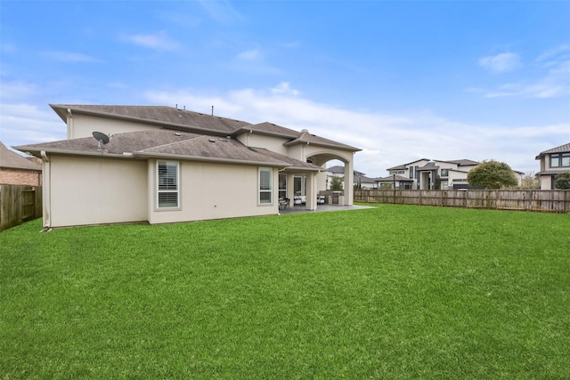 back of house featuring a yard and a patio area