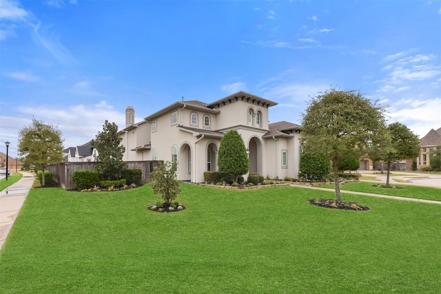 mediterranean / spanish-style house with a front yard