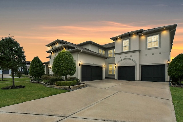 view of front of property featuring a garage and a yard