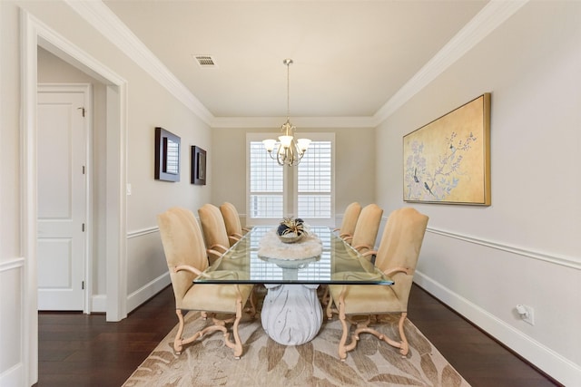 dining space with an inviting chandelier, ornamental molding, and dark hardwood / wood-style floors