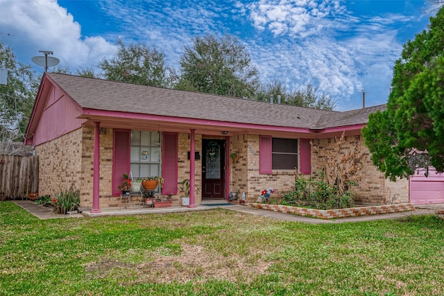 ranch-style home with a front yard and a porch