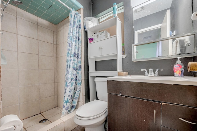 bathroom featuring vanity, walk in shower, and toilet