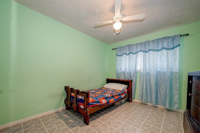 bedroom featuring ceiling fan and a textured ceiling