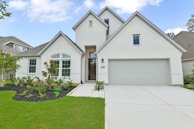 16119 Rustling Woods Rd, Conroe, TX 77302 - view of front facade featuring brick siding, driveway, a garage, and a front lawn