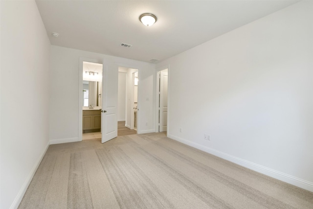 16119 Rustling Woods Rd, Conroe, TX 77302 - unfurnished bedroom featuring light colored carpet and connected bathroom