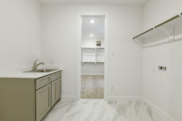 16119 Rustling Woods Rd, Conroe, TX 77302 - laundry room with washer hookup, cabinet space, light marble finish floors, and recessed lighting
