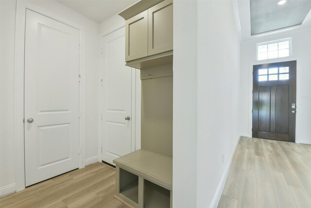 16119 Rustling Woods Rd, Conroe, TX 77302 - mudroom featuring light wood finished floors and baseboards
