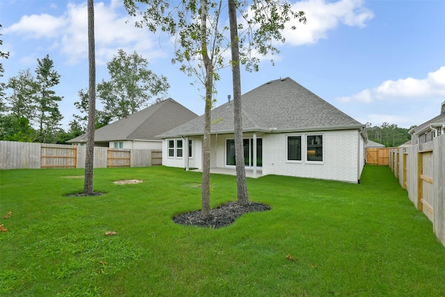 16119 Rustling Woods Rd, Conroe, TX 77302 - back of house with a fenced backyard, a shingled roof, and brick siding