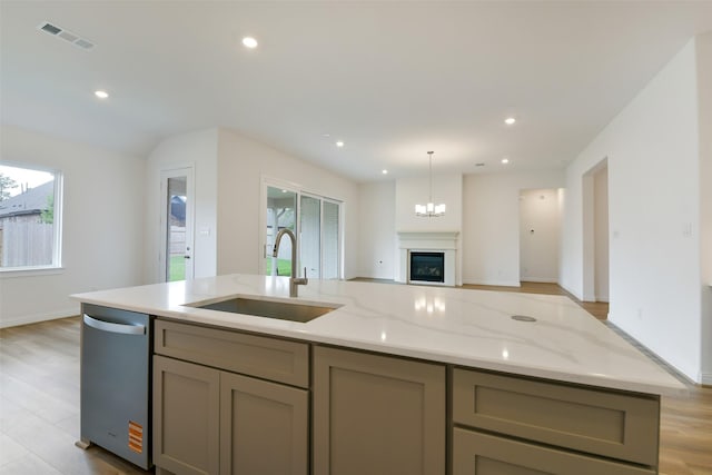 16119 Rustling Woods Rd, Conroe, TX 77302 - kitchen featuring stainless steel dishwasher, healthy amount of natural light, gray cabinetry, an island with sink, and recessed lighting