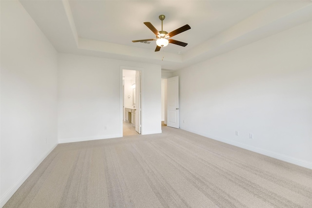 16119 Rustling Woods Rd, Conroe, TX 77302 - spare room with a raised ceiling, a ceiling fan, and light colored carpet