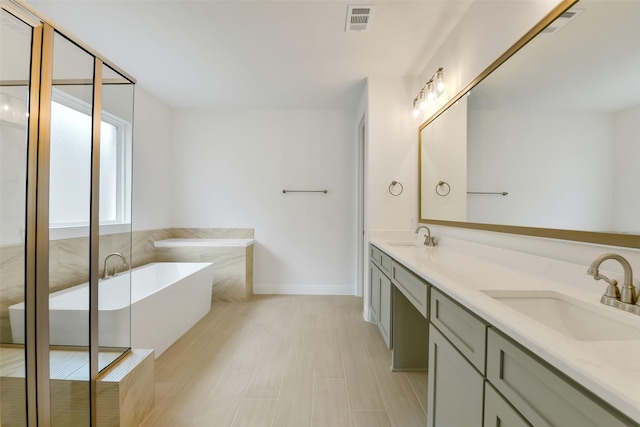 16119 Rustling Woods Rd, Conroe, TX 77302 - full bathroom featuring a freestanding bath and double vanity