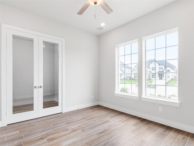 10903 Providence Ct, Missouri City, TX 77459 - empty room featuring ceiling fan, light wood-style flooring, and french doors